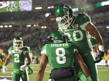 Saskatchewan Roughriders wide receiver Marcus Thigpen, centre, and Spencer Moore celebrate a touchdown against the Edmonton Eskimos during second half CFL action at Mosaic Stadium on Nov. 4, 2017.