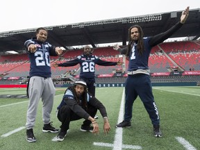 Toronto Argonauts linebacker Rico Murray, from left to right, defensive back Johnny Sears Jr., defensive back Cassius Vaughn and Marcus Ball ham it up for photographers during the final practice in Ottawa on Saturday, November 25, 2017.