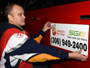 Les Francis (L) talks with the team of drivers who have volunteered for the annual Operation Red Nose campaign, driving home impaired people to reduce the number of drunks on the road and also raise donations for charity. November 25, 2016.