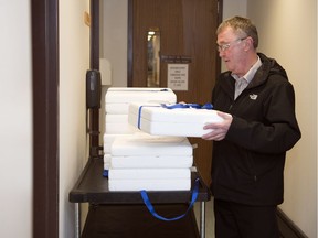 Ray Gartner, a volunteer with the Regina Qu'Appelle Health Region's Meals on Wheels program for 22 years, picks up food from the Regina General Hospital.