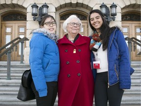 Dr. Ann Grahame, middle, stands with Rotary exchange students Runa Yamaguchi, left, of Japan and Flavia Trevisan, right, of Brazil out front the Legislative Building in Regina.