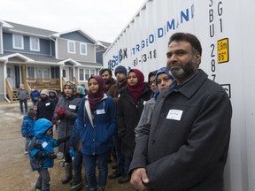 Nasir Shafi, right, looks on during speeches at a Habitat for Humanity event celebrating the second phase of Haultain Crossing at 1033 Edgar St. on Monday. Shafi will live in the Haultain Crossing community.