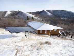 Jim Harding's house near Fort Qu'Appelle is powered by five solar panels and a 35-foot wind turbine.