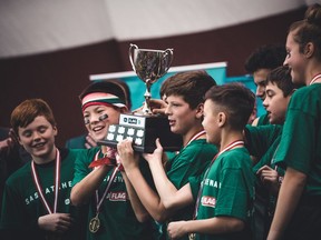 Members of the Junior Roughriders celebrate a national flag football title on Monday in Ottawa.