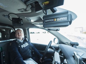 Const. Justin Beug looks up at the in-vehicle display that shows him a video feed from the dashboard camera. The White Butte RCMP detachment is part of a pilot project for the video system which captures both footage from the dashboard and the rear seat of the vehicle.