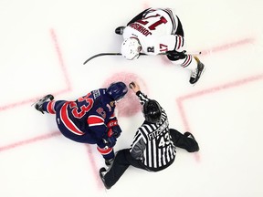 Regina Pats captain Sam Steel — shown facing off against the Red Deer Rebels' Reese Johnson, top, earlier this season — and his teammates are dealing with the pressure that accompanies being the Memorial Cup's host team.