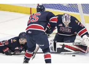 Regina Pats goalie Max Paddock keeps an eye on the loose puck in WHL action against the Calgary Hitmen on Wednesday at the Brandt Centre.