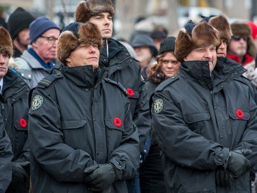 Members of the Regina fire department stand at the front of the crowd during the Remembrance Day service in Victoria Park.