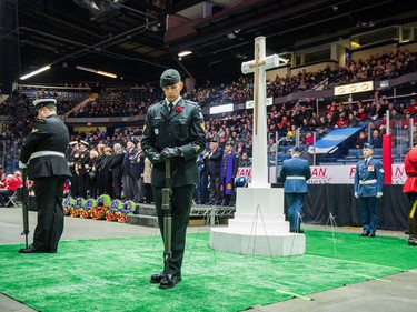 Sentries stand guard around a cross during the Remembrance Day service at the Brandt Centre.