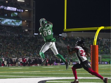 Saskatchewan Roughriders wide receiver Caleb Holley makes a mid-air touchdown catch while Ottawa Redblacks defensive back Sherrod Baltimore  looks on during an Oct. 18, 2017 CFL game held at Mosaic Stadium.