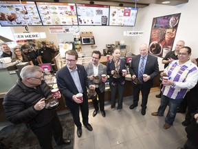 Sakimay First Nations Chief Lynn Acoose, fourth from left, pours coffee at the Saulteaux Crossing Business Park Esso Gas and Convenience Store just west of Regina. They are proud to be the first First Nations-operated Tim Hortons in Regina.