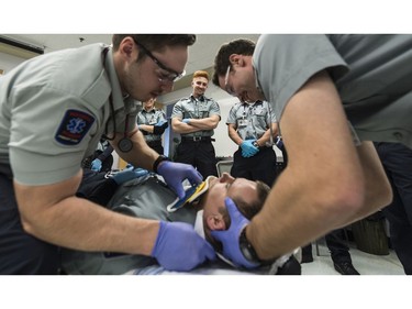 Daniel Adams, center, looks on as fellow Primary Care Paramedics practice at Saskatchewan Polytechnic.