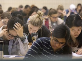University students take final exams in this file photo.