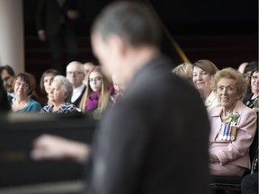 Pianist David McIntyre (foreground) plays a piece written for Jacqui Shumiatcher (right) prior to her receiving the Order of Canada, one of the country's highest civilian honours, at the Conexus Arts Centre on Thursday.