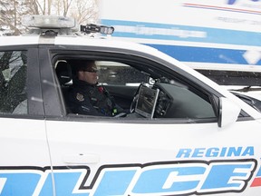 Constable Curtis Warnar of the Regina Police Service sits in a marked traffic unit police car that is equipped with an automated licence plate reader in Regina.