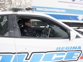 Const. Curtis Warnar of the Regina Police Service sits in a marked traffic unit police car that is equipped with an automated licence plate reader in Regina in November 2017.