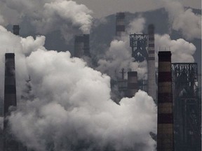 Smoke billows from smokestacks and a coal-fired generator at a steel factory on Nov. 19, 2015 in the industrial province of Hebei, China.