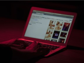 A computer user using the website backpage.com in Regina.  Sites like this and others are typically where escorts and massage parlours offer services.