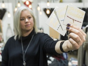 Lynette McGill holds wishing bracelets at Bella Chic clothing store in Emerald Park.