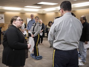 Sara Anderson (left), KAIROS blanket exercise co-ordinator, leads a group of RCMP officers and staff through the blanket exercise.