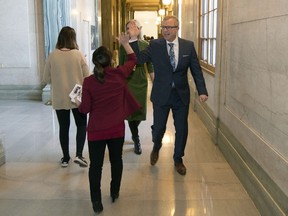 Premier Brad Wall high-fives a staff member after his last question period as premier at the Legislative Building in Regina.