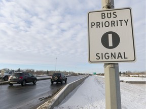 A bus priority signal sign faces east on Arcola Ave. overpass and the Ring Road alerts drivers to a new traffic signal for which to be aware.