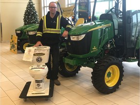 Peter Desiatnyk of South Country Equipment in Emerald Park poses with a toilet that was used for a WOLF 104.9 fund-raiser which assisted the Christmas Cheer Fund.