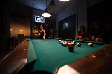 Michelle Ehman breaks during a game of pool at the Artful Dodger on the last night it was open for business.