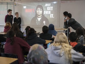 Grant Road School students Carter Coghill (left) and Jon Podbielski (second from left) present their Calls To Action project in their Grade 7/8 classroom.