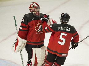 Canadian goalie Carter Hart and defenceman Josh Mahura, a member of the WHL's Regina Pats, celebrate their victoryn over the Czech Republic in world junior hockey championship pre-tournament action in London Ont., on Wednesday.