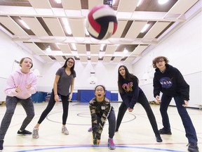 Tyler Graham (left), Tavah Delorme, Adrienne Sagun, Aaliyah Chartrand and Alex McDonald return some serves in the gym at Holy Rosary Community School. The team won the Regina Catholic School's girls volleyball championship on Monday.