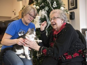 Louise Inglis, left, a volunteer with the Regina Humane Society, brings 3-year-old Sauron, on a pet therapy visit to Eleanor Biholar at the William Booth Special Care Home in Regina.