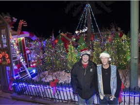 Super elves Mark Jaegli, left, and Brian Runge, president of the Normanview Residents Group, in front of Candy Cane Lane on Champ Crescent in Regina.