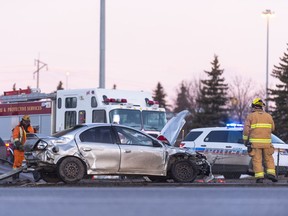 Regina Fire and Protective Services members clean-up at the scene of a collision near Albert St. N. on the Ring Road.