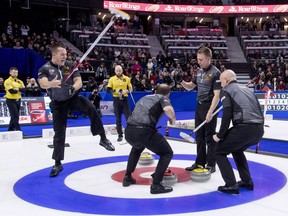 Regina product Ben Hebert (left) celebrates finishing first the Canadian Olympic team curling trials on Sunday with Calgary's Kevin Koe.