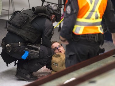 A SWAT member attends to an actor playing the role of a wounded person. MICHAEL BELL / Regina Leader-Post.