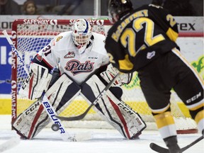 Regina Pats goalie Tyler Brown makes a save on Brandon Wheat Kings forward Ben McCartney during WHL action at the Brandt Centre on Thursday.