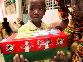 A child holds a shoebox delivered through Operation Christmas Child in this Postmedia News Group file photo. The Saskatoon Public School Division indicated Thursday it will not be supporting the charitable campaign in the future, as the organization that sponsors it, Samaritan's Purse, "does not fully align" with the division's values.