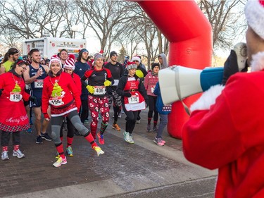 A man dressed as Santa Claus calls out warm up instructions as a group of runners get loosened up in preparation for the Santa Shuffle walk/run event that started at the Conexus Arts Centre in Regina on Saturday, Dec. 2, 2017.