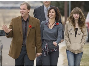 Saskatchewan Party leader Brad Wall, accompanied by wife Tami, centre, and daughter Megan, 13 years, arrives to vote Wednesday in the Saskatchewan provincial election at Fairview School in his home riding of Swift Current, SK.