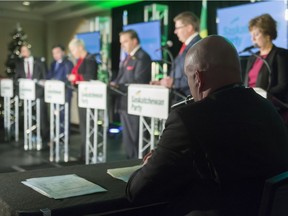 A moderator sits and watches the Saskatchewan Party leadership debate in Regina on Dec. 7, 2017.
