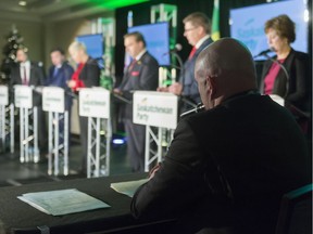 Saskatchewan Party leadership candidates take part in a debate held in Regina on Dec. 7. The moderator is sitting in the foreground.