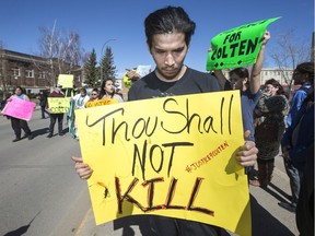 Colten Boushie's brother, William Boushie, holds a sign outside of the North Battleford provincial court at Gerald Stanley's preliminary hearing in North Battleford, SK on Thursday, April 6, 2017.