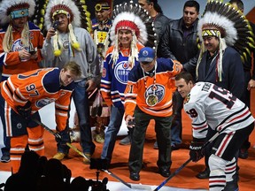 Ready to drop the puck for Connor McDavid (97) and Jonathan Toews, is Fred Sasakamoose, the first Native to play in the NHL, was appointed to the Order of Canada Friday and is being honoured at centre ice of the only visit of the Blackhawks this year agains the Oilers at Rogers Place in Edmonton, December 29, 2017.