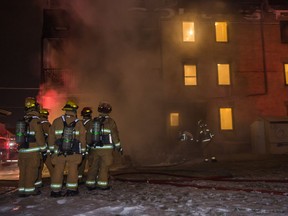 REGINA, SASK: Jan. 11, 2018 -- Firefighters attend to an apartment fire on the corner of 7th Ave. and Halifax Street on a frigid winter morning. The fire, which was reported just after 7 a.m., was contained to the exterior of the building and was largely extinguished 15 minutes after the fire department received the call. One person was treated on-scene for undetermined injuries. A total of five fire trucks and one smaller command vehicle were dispatched to the scene. The fire did not reach the building's interior. BRANDON HARDER/Regina Leader-Post