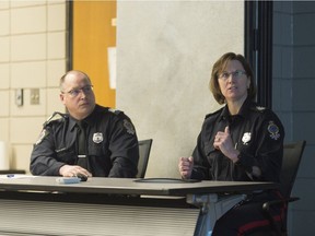 Staff Sgt. Kollin Erichsen, left, looks on as Sgt. Denise Reavley speaks about the school resource officer program during a meeting of the Board of Police Commissioners held at Regina Police Service headquarters.