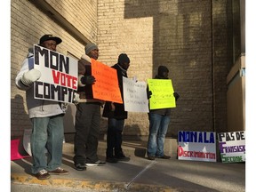 A group of protesters, including defeated candidate François Afane, gathered outside the Parktown Hotel in Saskatoon on January 13, 2018, to protest alleged racism and voter suppression in the Assemblée communautaire fransaskois election.
