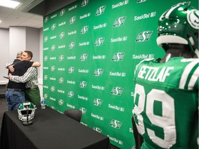 Chris Getzlaf hugs his father, Steve, shown on the left, after the veteran CFL receiver announced his retirement on Thursday at Mosaic Stadium.