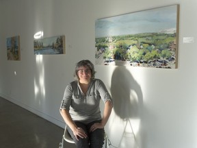 Heather Cline sits among her work at Slate Fine Art Gallery, where her exhibition Quiet Stories is on now.