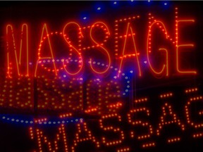 Neon signs from illicit massage parlours in Regina. New bylaws on the establishments will be before council later this month.